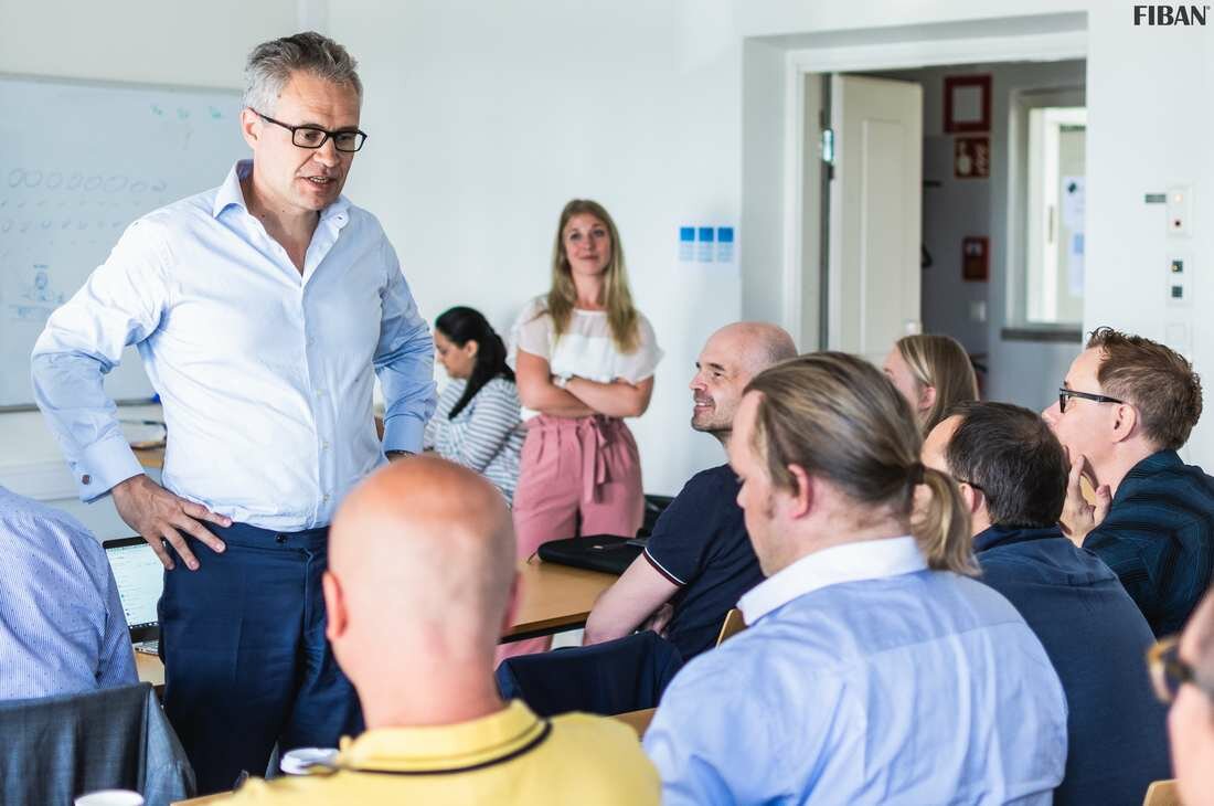 Speaker addressing seated participants at a Nordic Angel Program session hosted by FiBAN